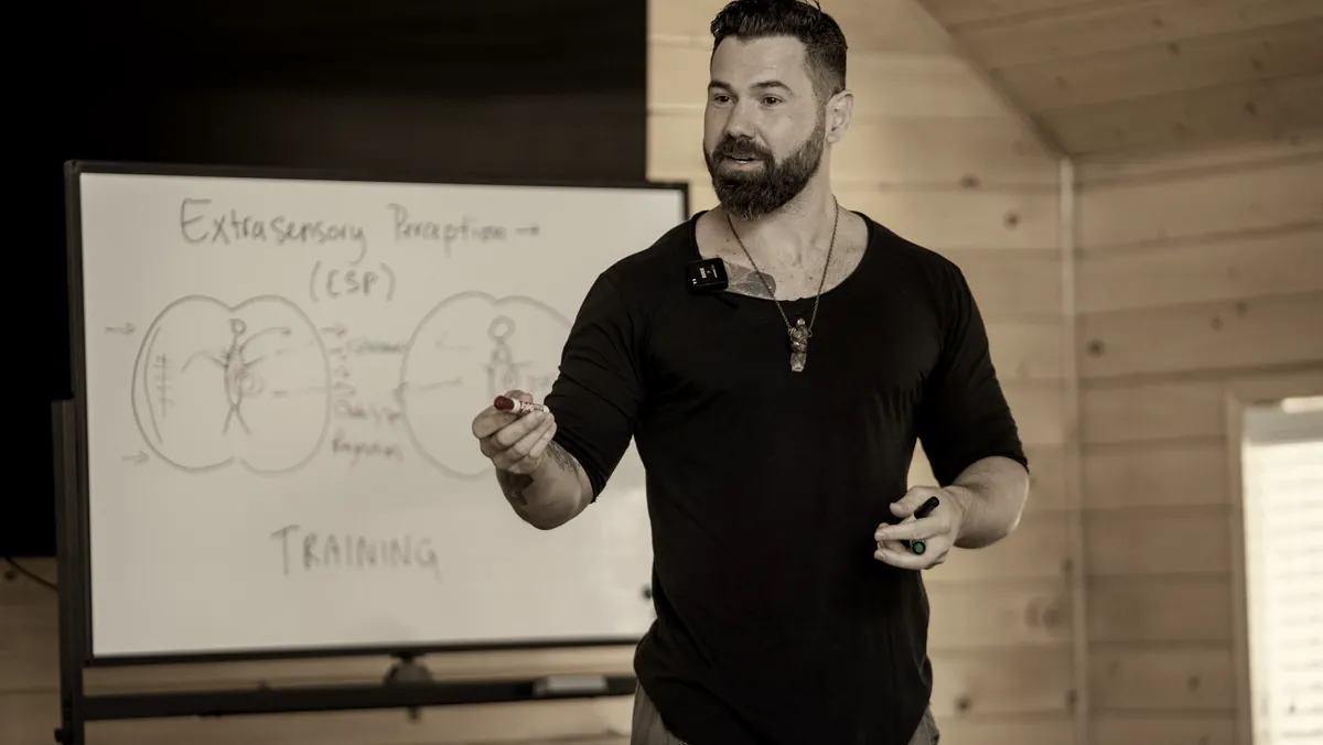 Zack Blakeney teaching at a whiteboard.