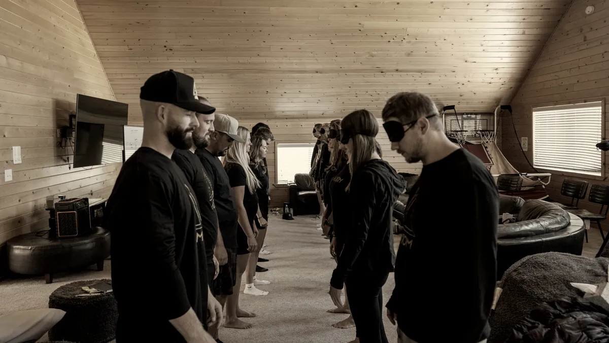 Participants practicing perception together in a wood-paneled room.